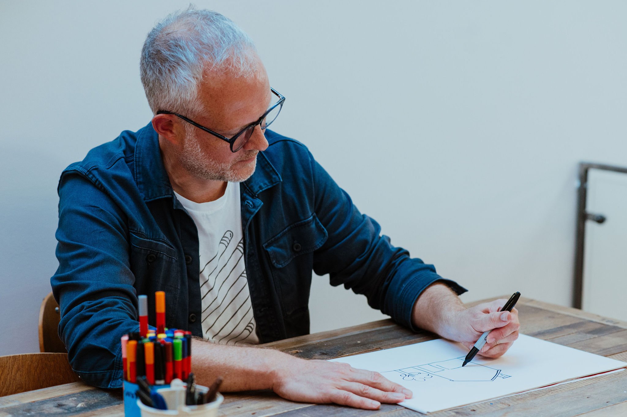 Scriberia co-founder Dan Porter, drawing at a table